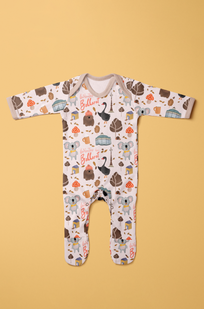 The image depicts a pink long-sleeved baby onesie with a whimsical illustrated pattern set against a sunny yellow background. The pattern features lovable characters and cheerful winter scenes from the popular children's book, 'Winter in Ballarat'. The characters and scenes are rendered in a playful and vibrant style, adding a delightful touch to the baby onesie. The onesie is an adorable and stylish addition to any baby's wardrobe, with the pink color complementing the cheerful pattern. The image evokes a sense of joy and playfulness, capturing the essence of the beloved children's book.